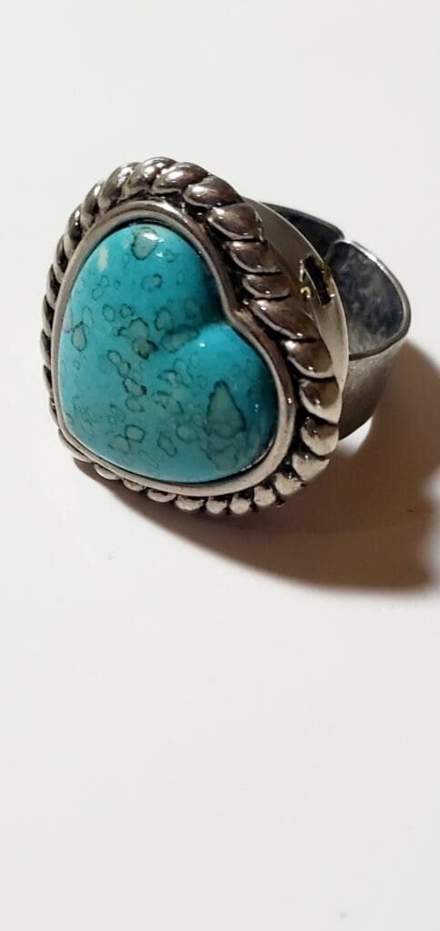 Turquoise heart-shaped ring with a silver rope design, showcasing natural patterns in the stone, ideal for lovers of unique jewelry.